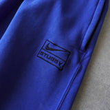 ステューシー × ナイキ NRG ゲームロワイヤル ロゴ スウェットパンツ トレーニングパンツ ブルー - NEWSED