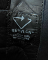 NEWSEDのPRADAモノリスRe-Nylonショートブーツに縫い付けられたブラックの再生ナイロン素材タグ