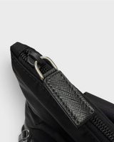 NEWSEDのPRADA Re-Nylonバックパック。ブラックのリサイクルポリアミド素材とサフィアーノレザーの引き手が付いたファスナー詳細。