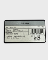 NEWSEDが販売するPRADAのラフィア製クロシェミニバケットバッグの製品タグ