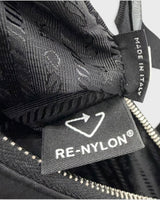 NEWSEDのPRADA Re-NylonタグとMADE IN ITALYのラベルが縫い付けられたブラックのナイロンバッグ内部