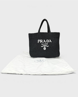NEWSEDのPRADAブラックラフィアクロシェトートバッグ。フロントにホワイトのトライアングルロゴ刺繍入り、保存袋付き。