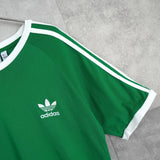 アディダス トレフォイルロゴ リンガーTシャツ グリーン × ホワイト - NEWSED